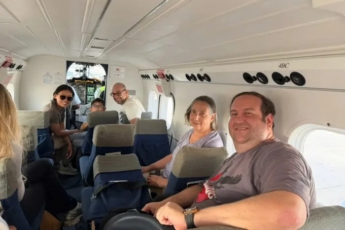 Kỳ nghỉ đảo lộn của khách Mỹ mắc kẹt tại Caribe do vụ không kích Venezuela Gia đình Morris trên chuyến bay sang đảo Canouan. Ảnh: BI