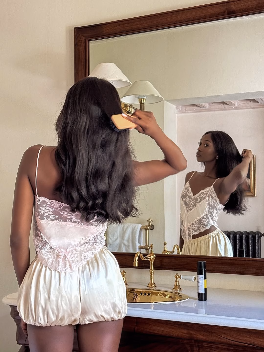 15 món beauty giúp tôi nâng cấp cả thói quen chăm sóc da lẫn trang trí nhà Emmanuelle Koffi brushing her hair while on a brand trip to Les Prés d'Eugénie.