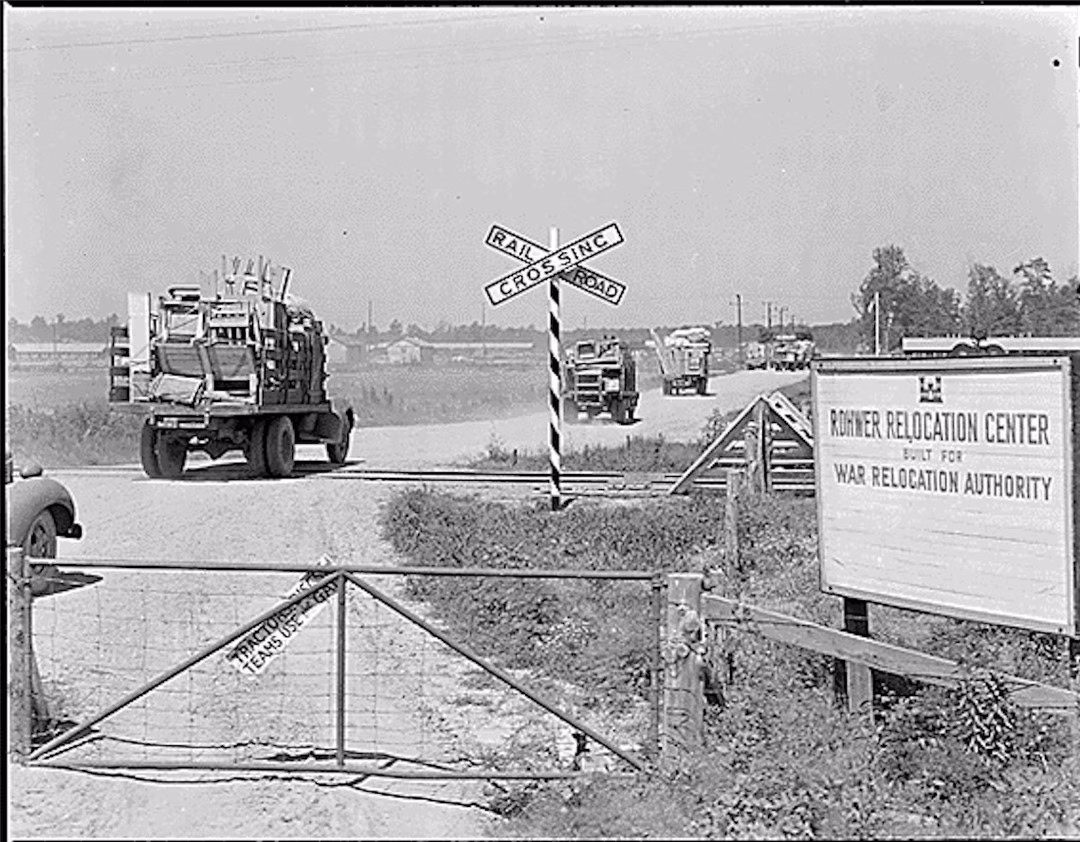 May be a black-and-white image of truck, trailer, lumberyard and text that says 'CROSSINC KaKoиap SINCI 4 CROS ROAD RONNER RELOCATION ROUNMERRELOCATIONCENTER CENTER BUILT FOR: WARRELOCATIONAUTHORITY WAR RELOCATION AUTHORITY HEACTO SEle USERGAT USE TEAMS EAMS'