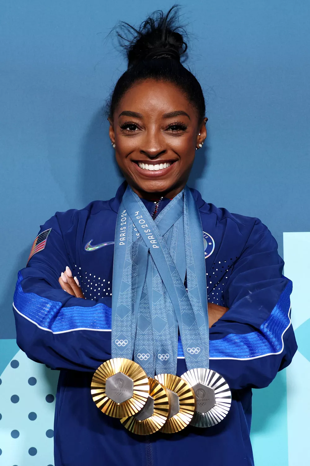 Simone Biles of Team United States poses with her Paris 2024 Olympic medals following the Artistic Gymnastics Women's Floor Exercise Final on day ten of the Olympic Games Paris 2024