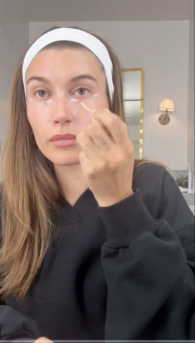 Hailey Bieber applies Kosas Revealer Extra Bright