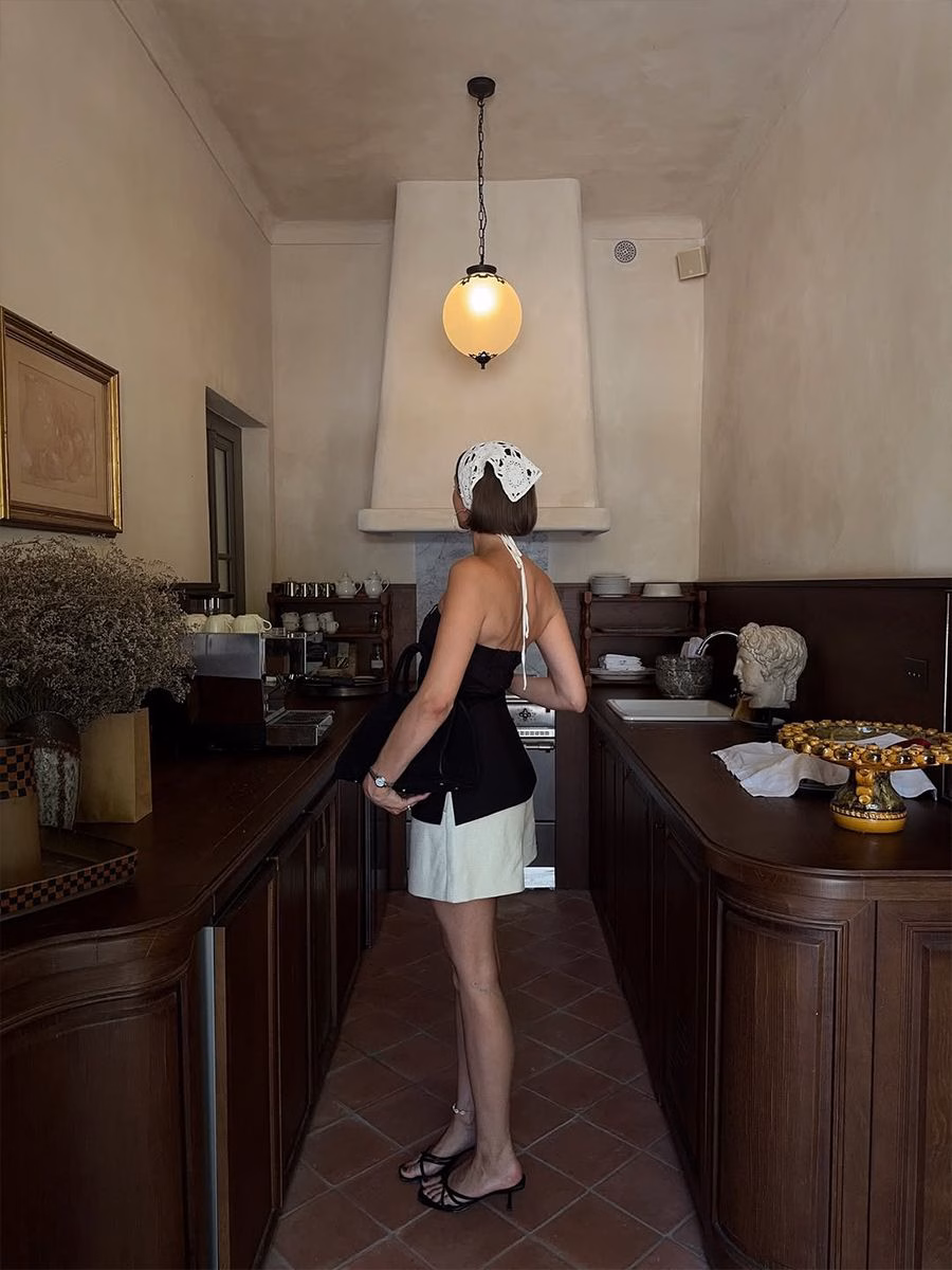 Mary L. Jean wears a black top with a white skirt while visiting The French Riviera.