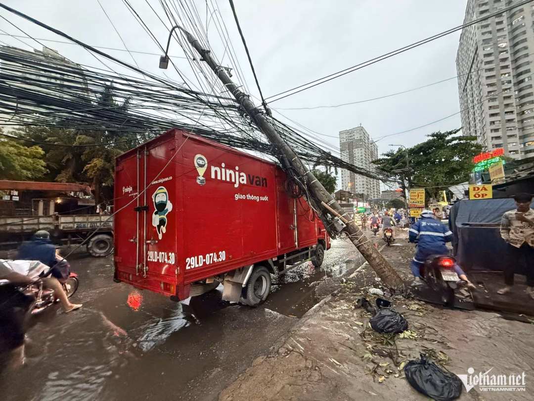 Hà Nội: Cây xanh bật gốc đè lên xe Lexus LX570 và Hyundai Tucson trong cơn mưa giông Cách đó không xa, một xe tải cũng bị cột điện đổ trúng khi đang di chuyển ở đường 70 (Thanh Trì, Hà Nội). Ảnh: Đình Hiếu