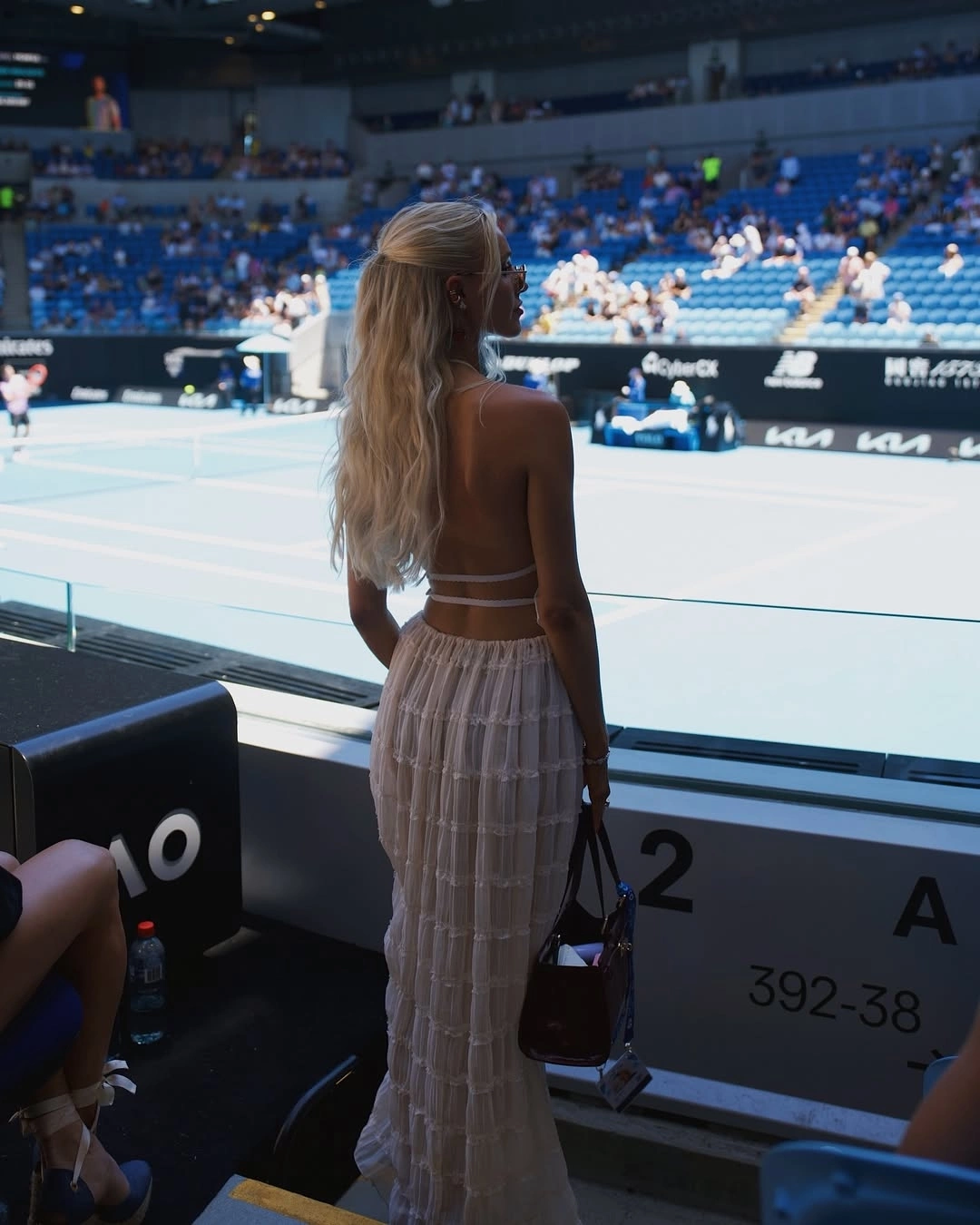 Trong một lần đến cổ vũ Taylor Fritz, cô chọn đầm hở lưng và túi xách hàng hiệu.