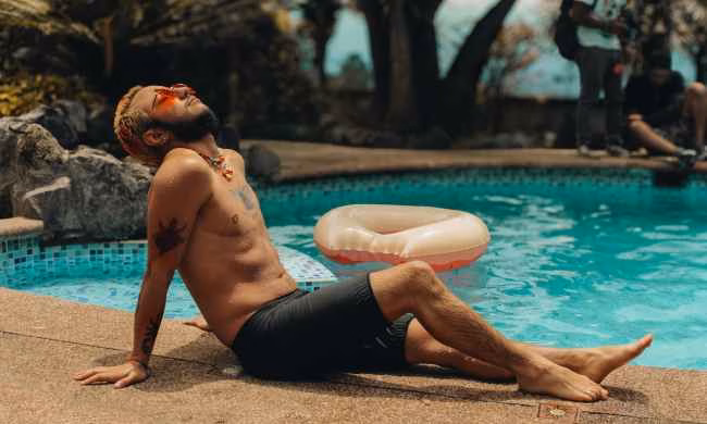 man relaxing in sun sunbathing