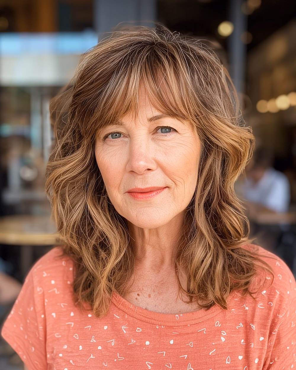 Medium-length haircut with choppy layers and soft waves on light brown hair