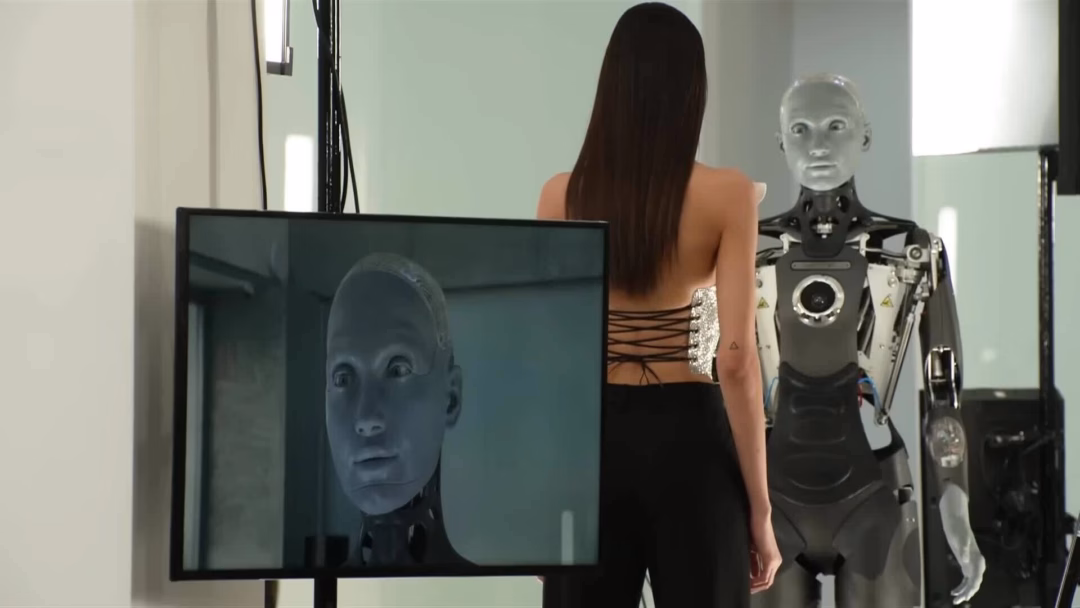 Tương lai của ngành thời trang: Robot trở thành đồng nghiệp của người mẫu trên sàn diễn Trong vai nữ anh hùng Ellen Ripley của phim "Alien", người mẫu Maggie Maurer ôm một con búp bê đính pha lê Swarovski và chip, bo mạch điện tử ở show Schiaparelli. Ảnh: Gorunway