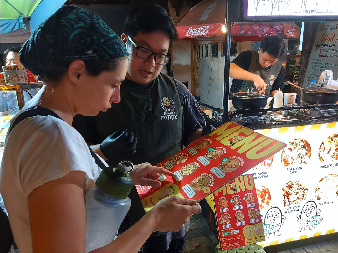 Trải nghiệm gọi món bằng tiếng Anh tại quán khoai tây Tống Duy Tân Du khách quốc tế đang trao đổi với nhân viên bằng tiếng Anh để chọn topping món ăn