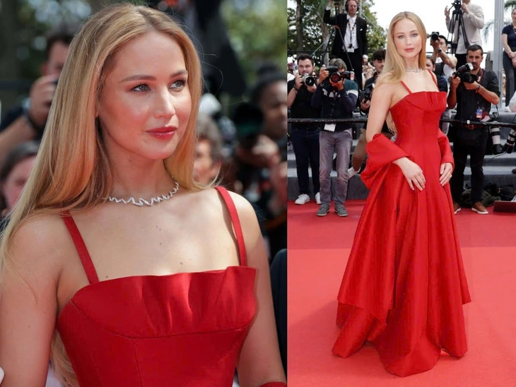 Phong cách điện ảnh của Jennifer Lawrence trên thảm đỏ Tại Liên hoan phim Cannes 2023, Jennifer Lawrence thu hút mọi ánh nhìn khi diện chiếc đầm đỏ ôm trọn vóc dáng mảnh mai của mình, tôn lên đường cong thanh thoát nhờ kỹ thuật cắt may chuẩn xác. Điểm nhấn đặc biệt trong tổng thể trang phục là chiếc vòng cổ kim cương và dải khăn satin đỏ buông nhẹ trên cánh tay, tạo nên vẻ kiêu kỳ và lãng mạn, như bước ra từ một câu chuyện cổ tích - Ảnh: NEWS18