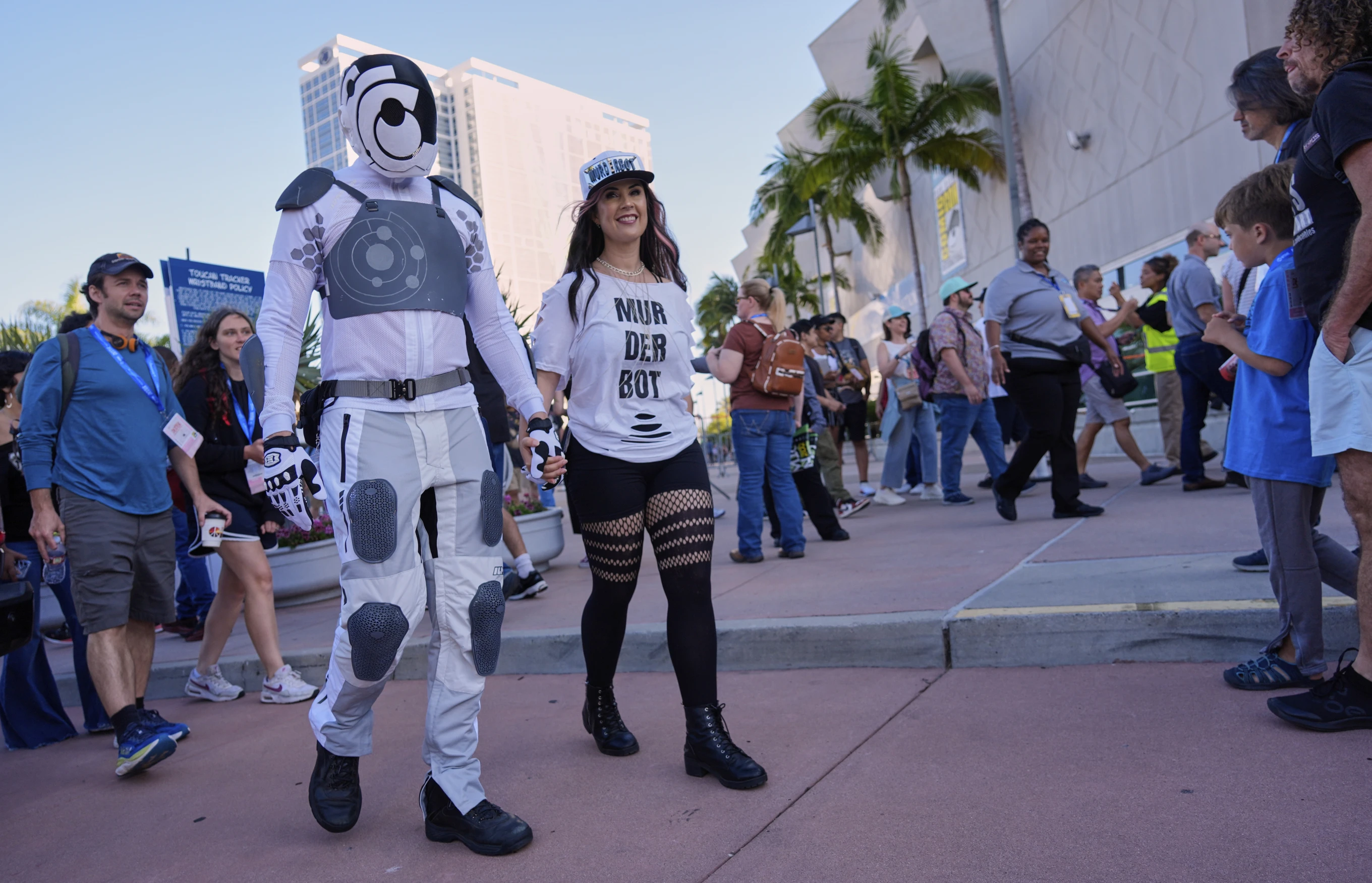 Chris Lane, left, and his wife Shannon, wearing costumes inspired by the Apple TV+ series “Murderbot,” walk through the crowd before the 2025 Comic-Con International Preview Night on Wednesday, July 23, 2025, in San Diego. (AP Photo/Chris Pizzello)