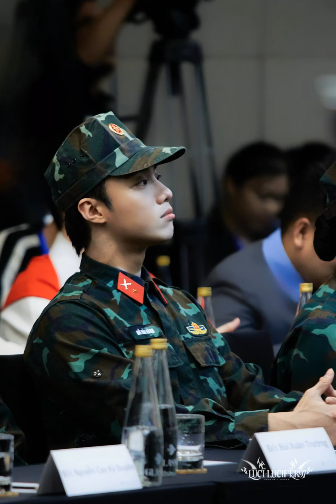 May be an image of 1 person, hat, military uniform, top and text
