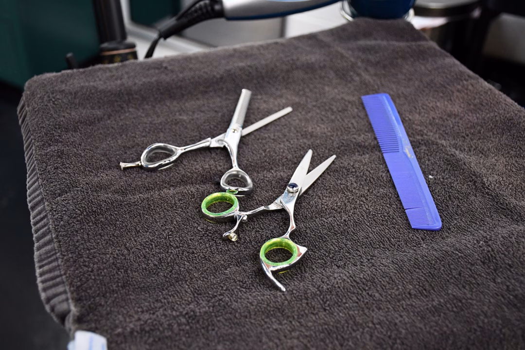 Tools of the trade—including shears and a comb—sit on a towel inside a Mississippi salon. With limited staff and no confirmed board members, oversight of salons statewide is under strain. Photo by RHCJC News
