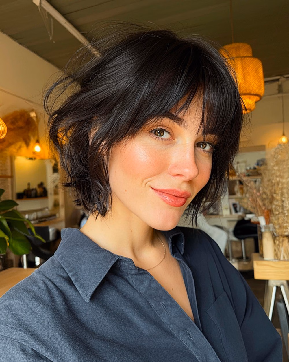 Textured 90s-inspired short black bob with tousled layers and soft fringe