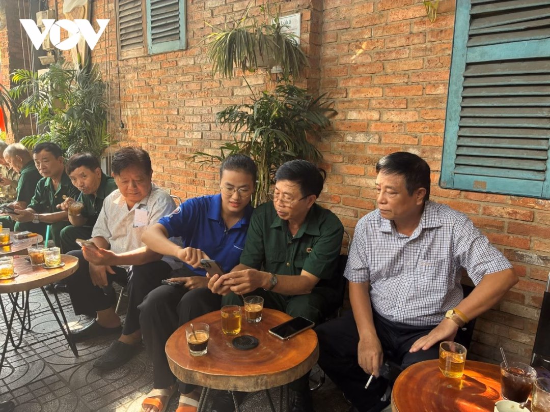 Cựu chiến binh Ngô Văn Tá (thứ 2 từ phải sang) đang được tình nguyện viên hướng dẫn