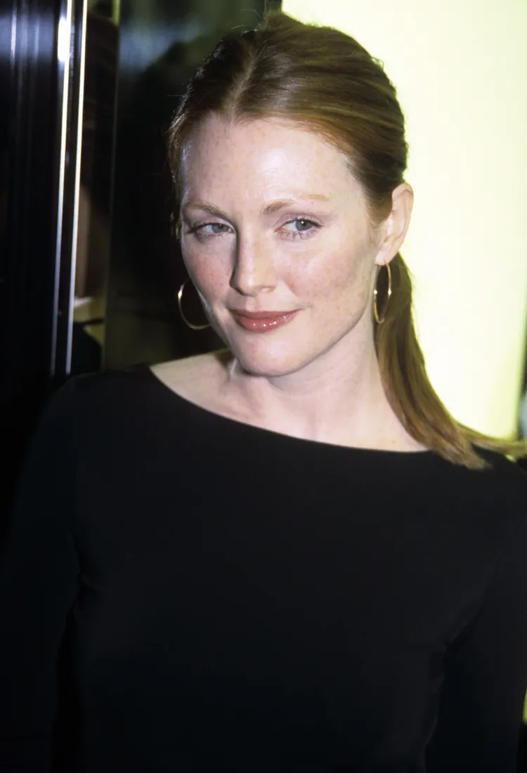 Young Julianne Moore with her hair in a ponytail wearing hoop earrings