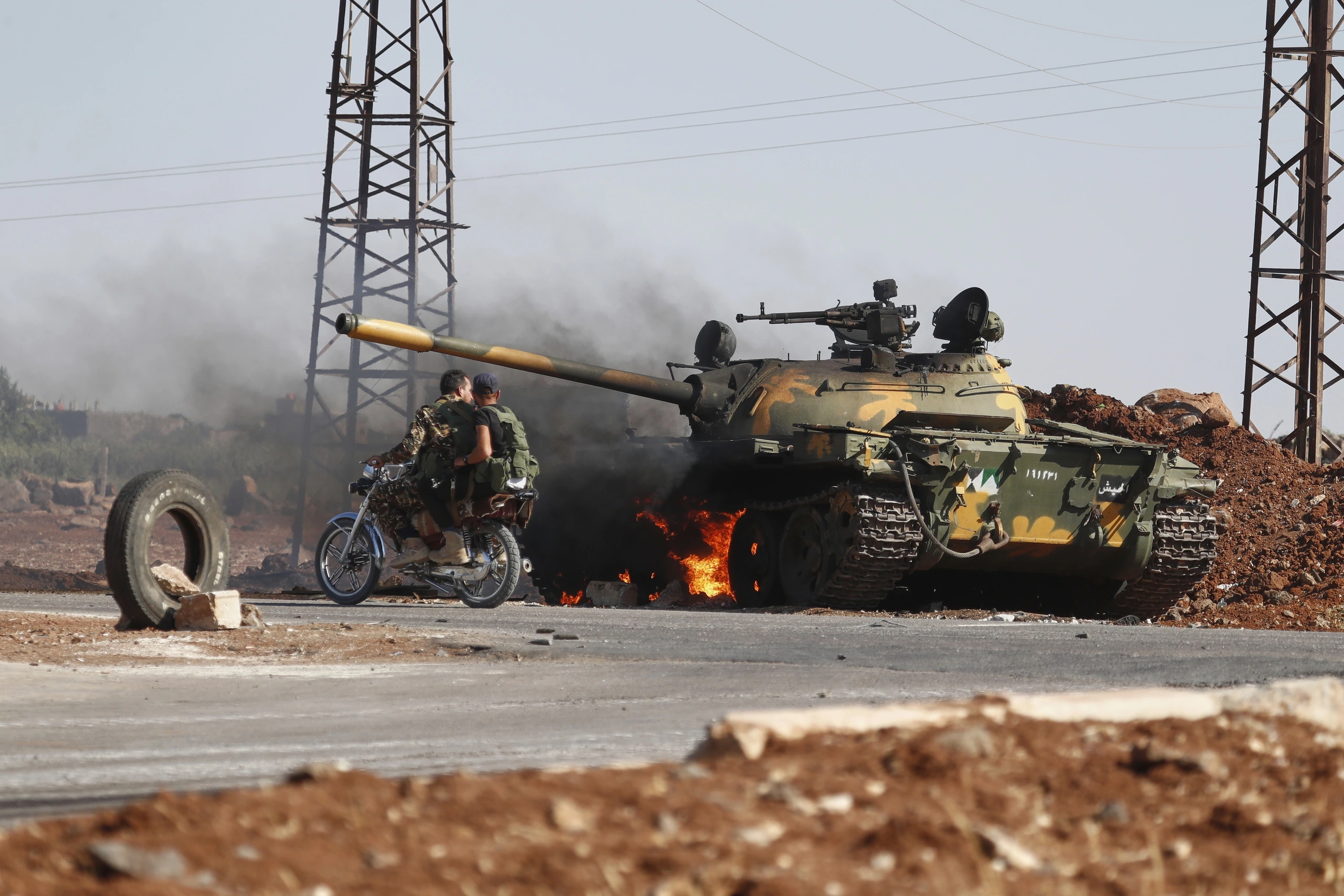 Quân đội Syria tiến vào thành phố Sweida sau hai ngày xung đột Quân chính phủ Syria đi ngang chiếc xe tăng bị cháy ở ngoại ô Sweida ngày 14.7