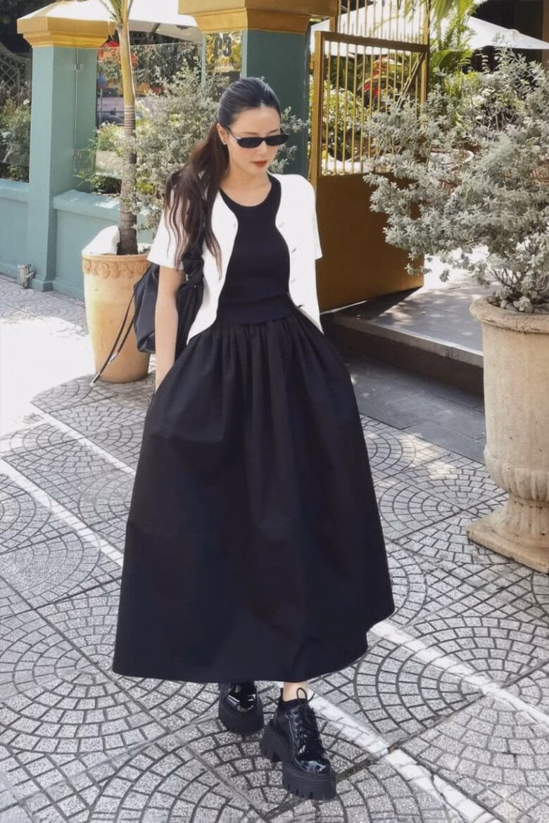 Midu khoe outfit lên giảng đường với phong cách trẻ trung khi mix đầm đen liền thân cùng áo khoác lửng trắng đối lập, hoàn thiện bằng đôi Oxford độn đế giúp tổng thể vừa gọn gàng vừa năng động.