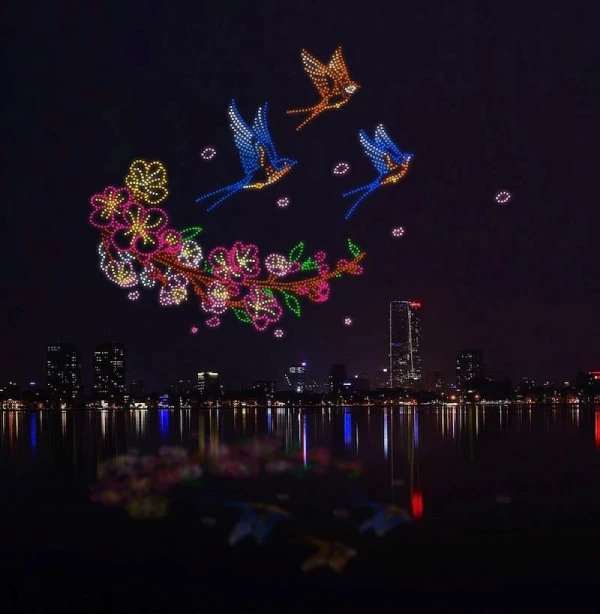 Hình ảnh chim én cùng hoa mai, hoa đào đón xuân sang